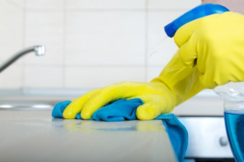 Cleaner removing fine dust after building work in a Camden flat